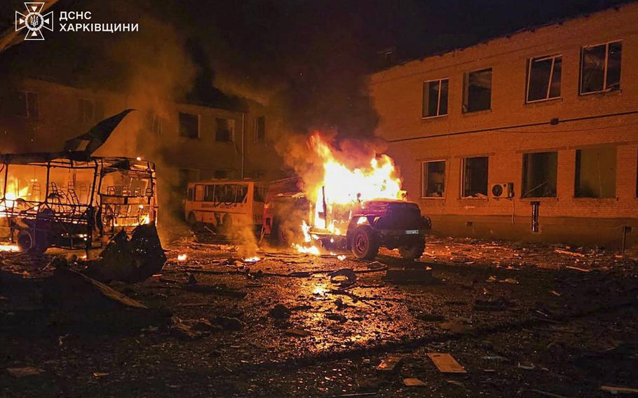 A Fire engine and school bus burning after a drone attack.