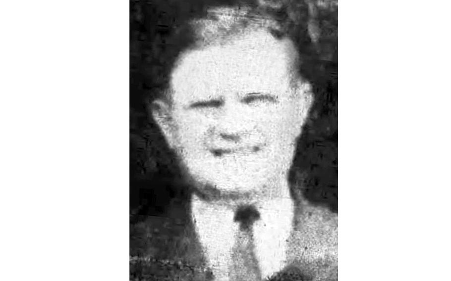 A blurry, black-and-white 1940s-era portrait of a man in a suit, shown from the neck up.