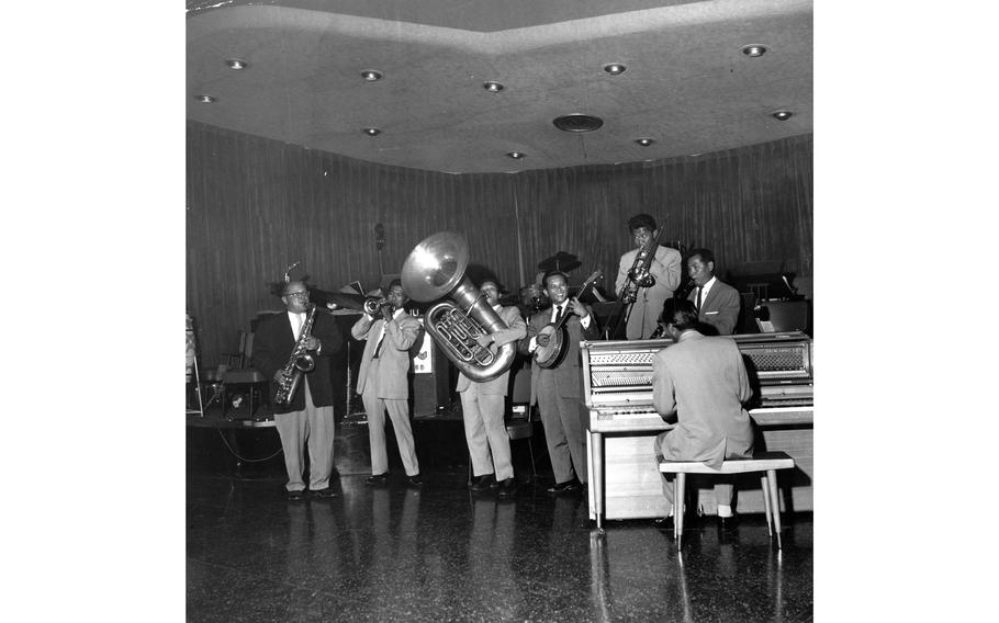 Vernon Brotman (standing, far right behind piano), leads the 14-member Filipino Rocker Club band at the Kadena Air Base Rocker Club, one of the several “Rocker clubs” for service members dotting the Pacific theater. The band members were all veteran musicians. Brotman played five instruments and also sang. Pictured here are the other members of the band (left to right): trumpet player Silvester Roxas, tuba player Jaime Alarcom, guitarist-violinist “Tiny” Umali, trombonist Rommy Reyes, and piano player Vic Ares.