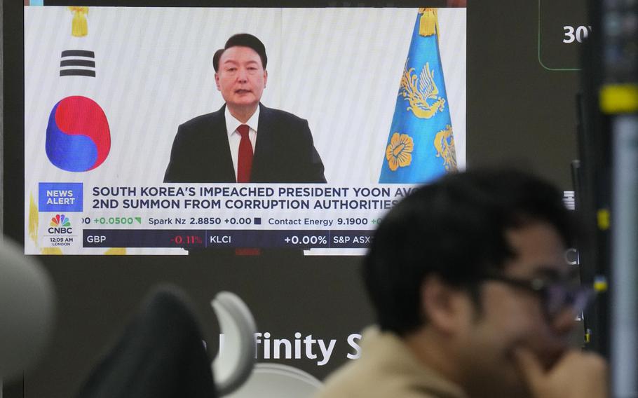 A television screen shows a picture of South Korean President Yoon Suk Yeol.