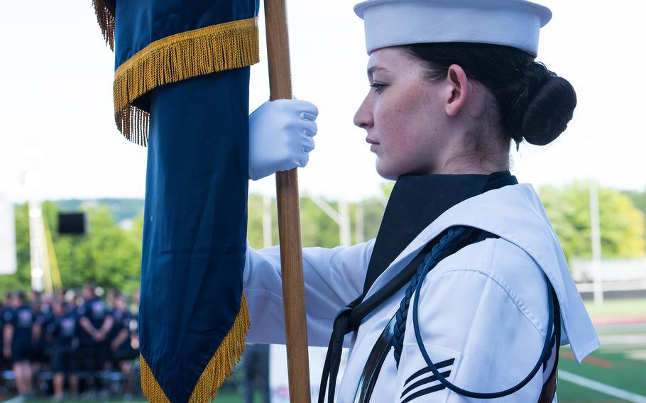 A U.S. Navy sailor holds the service’s colors during an opening ceremony