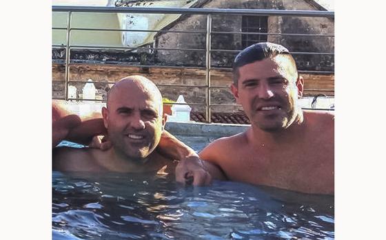 This October 2014 photo obtained by The Associated Press shows then-U.S. Drug Enforcement Administration Agents Jose Irizarry and George Zoumberos in a rooftop pool at a luxury hotel in Cartagena, Colombia, during a DEA assignment for "Operation White Wash." Irizarry long considered Zoumberos a brother but in his interviews with investigators accused his former partner of a list of crimes. (AP Photo)