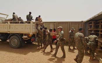 U.S. service members work alongside Nigerien soldiers to load desks for a local school onto a truck at Air Base 201 in Agadez, Niger, on June 18, 2024. The U.S. began pulling out of the base in May, and the Defense Department announced Aug. 5, 2024, that the withdrawal from Air Base 201 is complete.