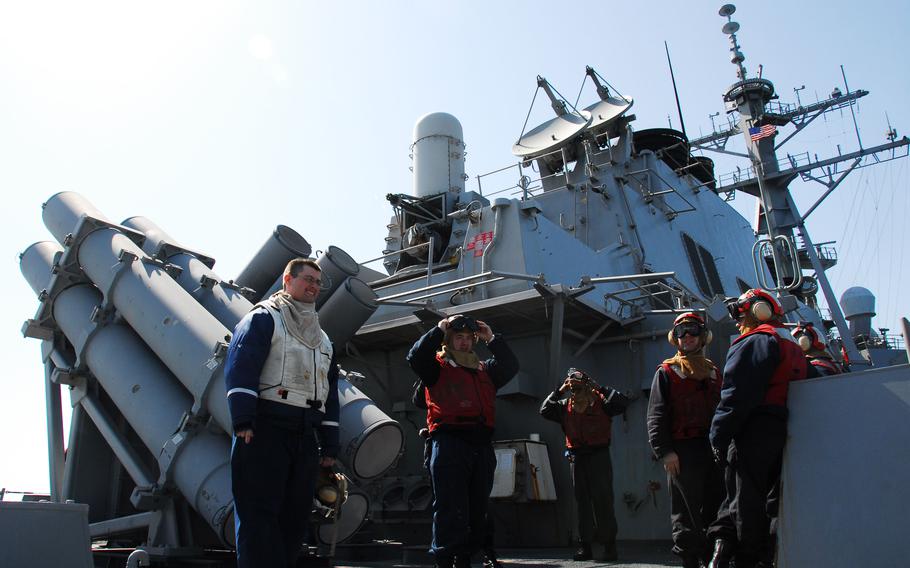 Crew members of the USS Curtis Wilbur wait for the arrival of a helicopter on April 3, 2010. The Curtis Wilbur is one of four U.S. ships standing by to assist in a rescue efforts to get to 46 South Korean sailors missing after the South Korean ship Cheonan sank on March 26. Most of the South Korean and U.S. ships at the wreckage site are also there as a deterrent to nearby North Korea, according to the U.S. Navy officer in charge of the American forces there.