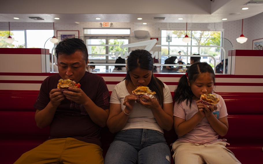 The Lei family tries hamburgers at an In-N-Out restaurant near their new home in Hacienda Heights. Muhan, who had seen videos of “American-style hamburgers” on Chinese TikTok, said she enjoyed her first meal out.