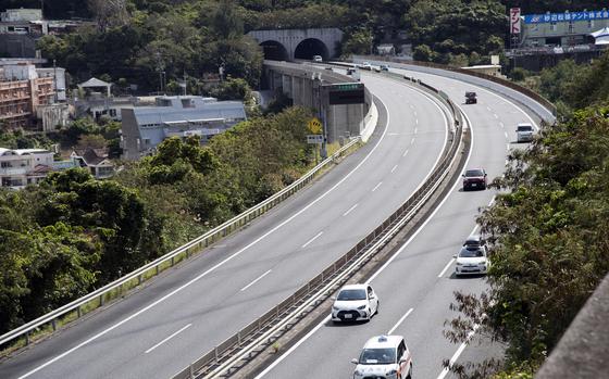 Cars drive along the Okinawa Expressway near Camp Foster, Okinawa.