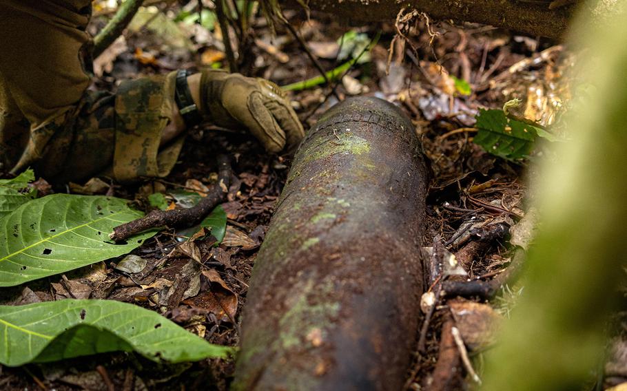 Marine Corps Sgt. William Barker, an explosive ordnance disposal technician with Marine Rotational Force – Darwin, uncovers a World War II-era shell in Munda, New Georgia, Solomon Islands, Sept. 9, 2024.