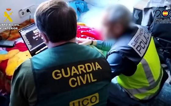 A screenshot from a Spanish national police video posted Feb. 5, 2025, shows authorities checking a computer seized from a man they described as a "dangerous hacker." He is accused of carrying out more than 40 cyberattacks against the U.S. military, NATO and other organizations.