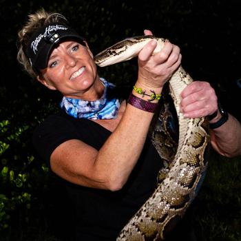 Python Huntress Amy Siewe holds an invasive 10-foot Burmese Python on Sept. 5 in Miami. Her biggest snake measured 17 feet 3 inches and weighed a whopping 110 pounds. Siewe, a petite 5 foot 4, relies on outsmarting snakes that large, not outmuscling them. Still, it helps to be fearless and fast. 