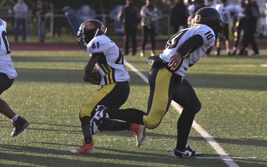 Stuttgart quaterback Kai Lewis completes a handoff to junior running back Sammy Johnson during a game against Wiesbaden on Sept. 13, 2024, in Wiesbaden, Germany.