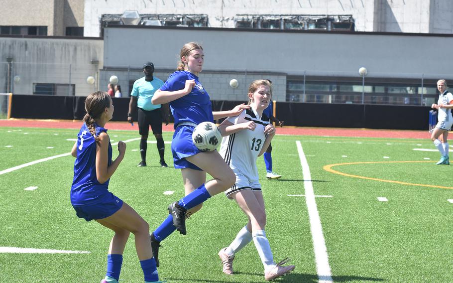 Wiesbaden's Nora Hygh makes contact her hip as SHAPE's Georgia Green and Wiesbaden's Loren Venton watch Monday, May 20, 2024, at the DODEA European Division I girls soccer championships at Ramstein Air Base, Germany.