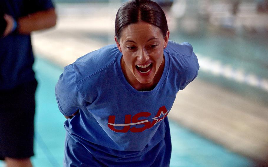 Army Sgt. 1st Class Elizabeth Marks talks to Stuttgart Piranhas swimmers during an open practice session with the U.S. Paralympic swim team on Aug. 20, 2024, at a pool in Sindlefingen, Germany. Marks is one of 33 members on the U.S. squad that will compete in Paris during the 2024 Paralympic Games.