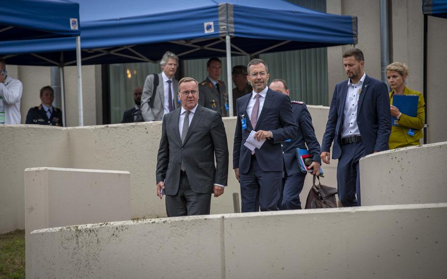 German Defense Minister Boris Pistorius, left, walks to meet with reporters during the Ukraine Defense Contact Group meetings at Ramstein Air Base, Germany, Sept. 6, 2024. Pistorius said his government pledged to deliver 12 additional Panzerhaubitze 2000 howitzers to Ukraine, with six arriving before year's end.