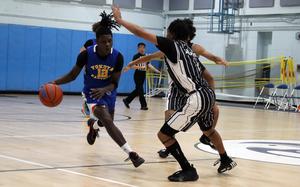 Yokota's Jai Bailey drives against Zama's Ayden Helton. Bailey was named D-II boys MVP last year; Helton received the honor Wednesday in this year's tournament.