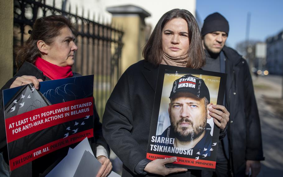 Belarusian opposition leader Sviatlana Tsikhanouskaya holds a portrait of her jailed husband in March 2024