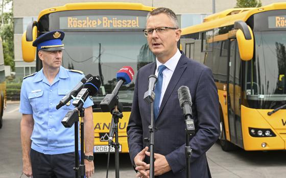 Hungary's State Secretary Bence Rétvári, right, and National Deputy Chief of Police Janos Kuczik hold a joint press conference at the bus station of Nepliget, Budapest, Hungary, Friday Sept. 6, 2024. (Tibor Illyes/MTI via AP)