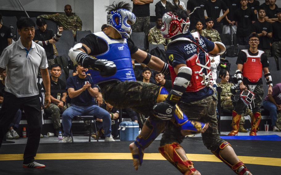 Two military members engage in a match during a taekwondo exhibition in Carey Fitness Center at Camp Casey, South Korea, on June 28, 2024.