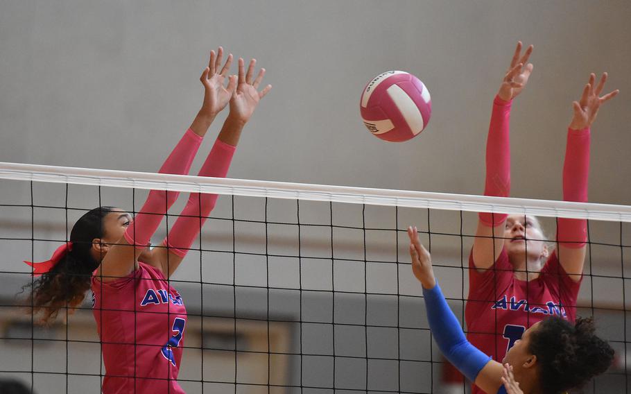 Sigonella's Alysia Dobbins manages to get the ball in between Aviano blockers Jazmyn Warren, left, and Addison Krajicek on Saturday, Oct. 5, 2024, at Aviano Air Base, Italy.