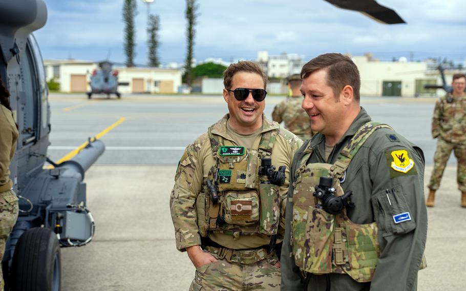 Lt. Col. Louis "Shiner" Nolting, 33rd Rescue Squadron commander, left, and Lt. Col. Brian Rhoades, combat rescue helicopter team lead, step toward an HH-60W Jolly Green II for its first flight at Kadena Air Base, Okinawa, Feb. 27, 2024. 