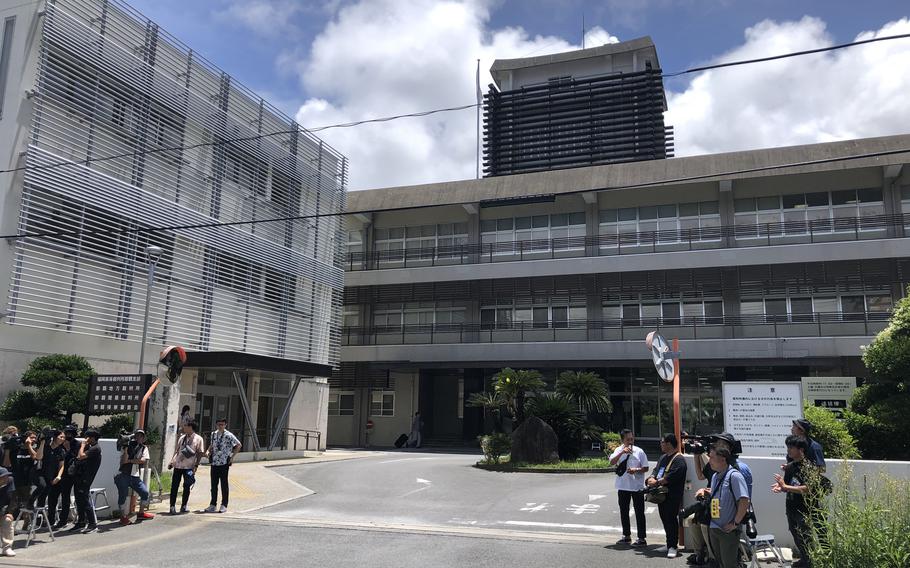 Members of the Japanese media wait outside the Naha District Court July 12, 2024, before the start of hearing on charges a U.S. Air Force member kidnapped and sexually assaulted a minor.