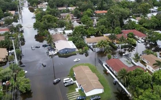 This arial view taken from video shows a flooded street in Northeast Miami-Dade County on Thursday, June 13, 2024. A tropical disturbance brought a rare flash flood emergency to much of southern Florida the day before. Floridians prepared to weather more heavy rainfall on Thursday and Friday. (AP Photo/Daniel Kozin)