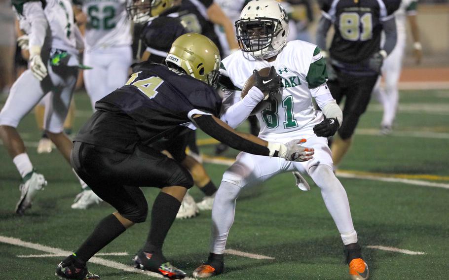 Kubasaki's Malachi Pinkston gets bottled up by Humphreys' Christian Orlanda.