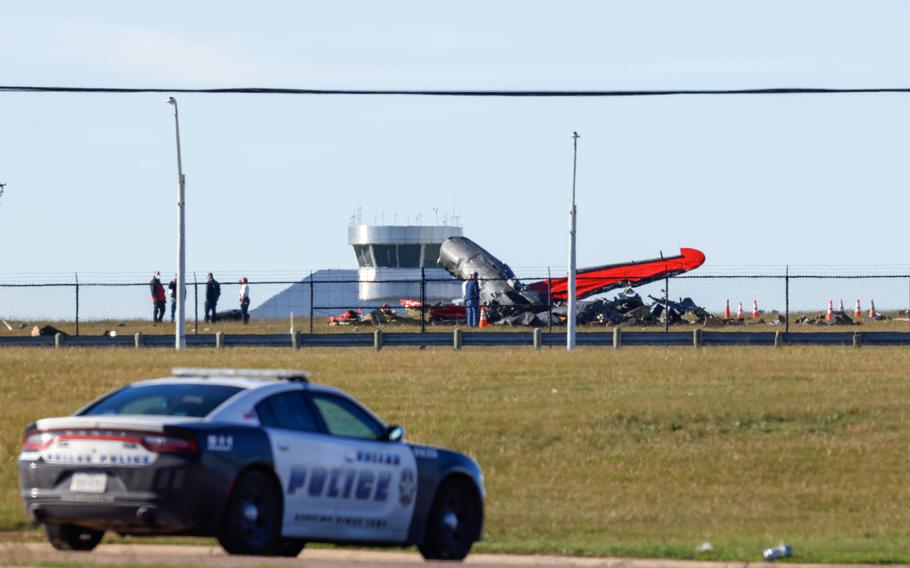 Police respond to a mid-air collision between two planes within the fence line of the Dallas Executive Airport on Saturday, Nov. 12, 2022. A year after the mid-air collision between two World War II-era aircraft killed six crewmen in front of a large crowd, the Commemorative Air Force will host its annual Veterans Day Weekend event in Dallas without the air show.