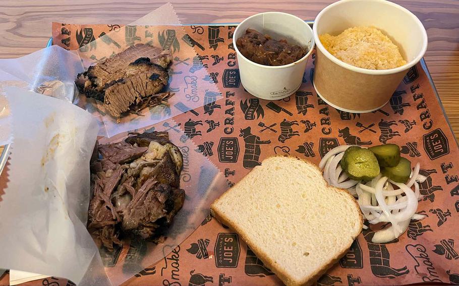 Elements of a barbecue meal and side dishes are displayed on a tray.