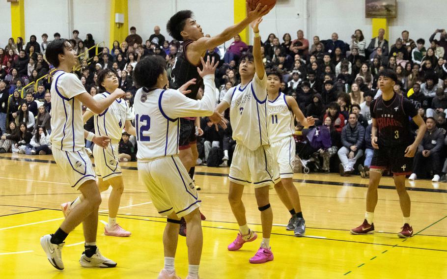 David Del Carmen drives to the basket.