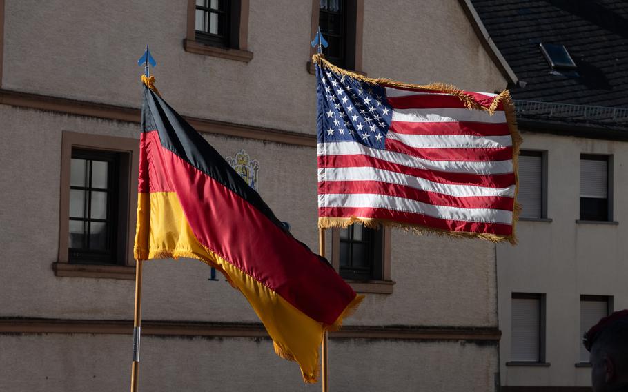 U.S. and German flags are shown waving