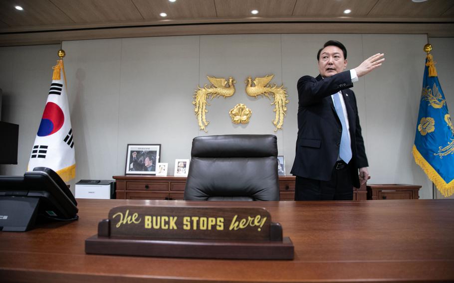 South Korean President Yoon Suk Yeol in his office this month. The plaque on his desk that reads “The buck stops here!” was a gift from President Biden.