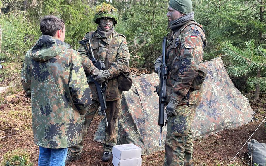 A visitor talks to German troops