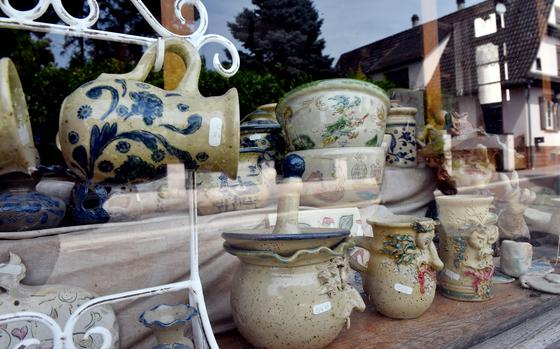 Ecletic pottery works are displayed in the window of Pascal Stecher’s tiny workshop in Betschdorf, France. Stecher is fascinated by witches and dragons and often includes their images on his pottery.

