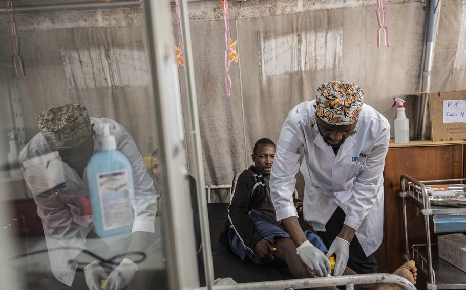 Medics treat a man wounded 