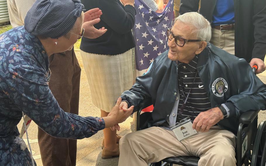 WWII veteran Joe Kallist shakes hands on Monday, June 3, 2024, with a well-wisher from the Normandy commune of Houlgate, France.