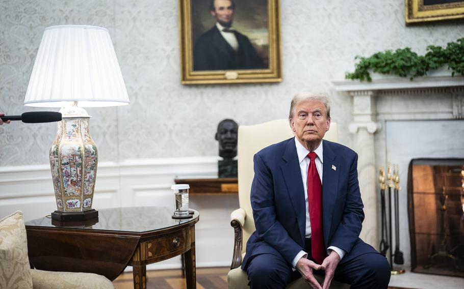 President-elect Donald Trump sits in the Oval Office during a November meeting with President Joe Biden. 