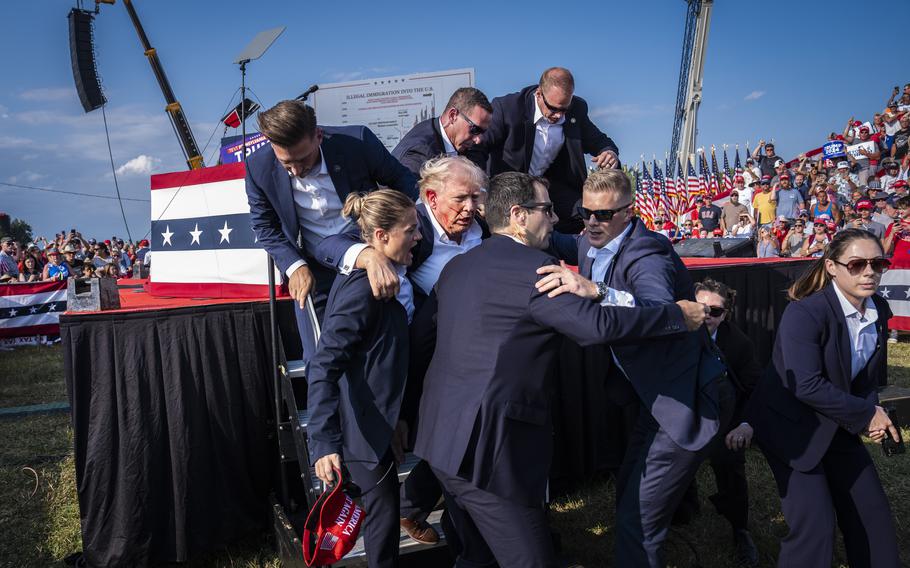 Secret Service agents remove Donald Trump from the stage with blood on his face during his rally Saturday, July 13, 2024, in Butler, Pa. 