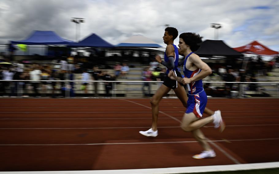 Ramstein’s Tyrell Downs runs alongside a teammate during the boys 1,600 meter varsity race at the 2024 DODEA European Championships at Kaiserslautern High School in Kaiserslautern, Germany, on May 24, 2024. Downs achieved a personal record of 4:49.01.