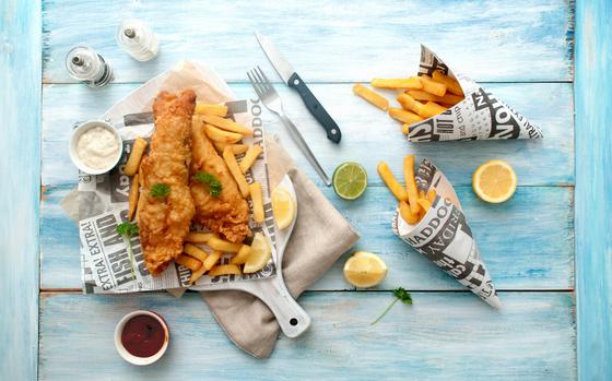 Traditional fish and chips takeout wrapped in newspaper