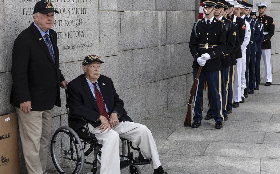 World War II Navy veteran Les Jones and the Armed Forces Color Guard await the start of the 20th anniversary celebration of the National World War II Memorial in Washington, May 25, 2024.