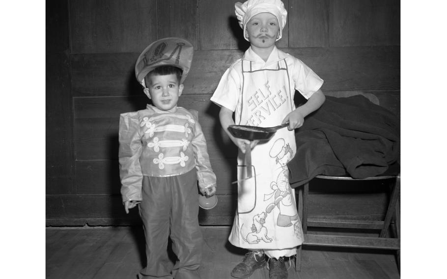 A chef and what appears to be a pint-sized British King's Guard, on leave from Buckingham Palace pose for the photographer.