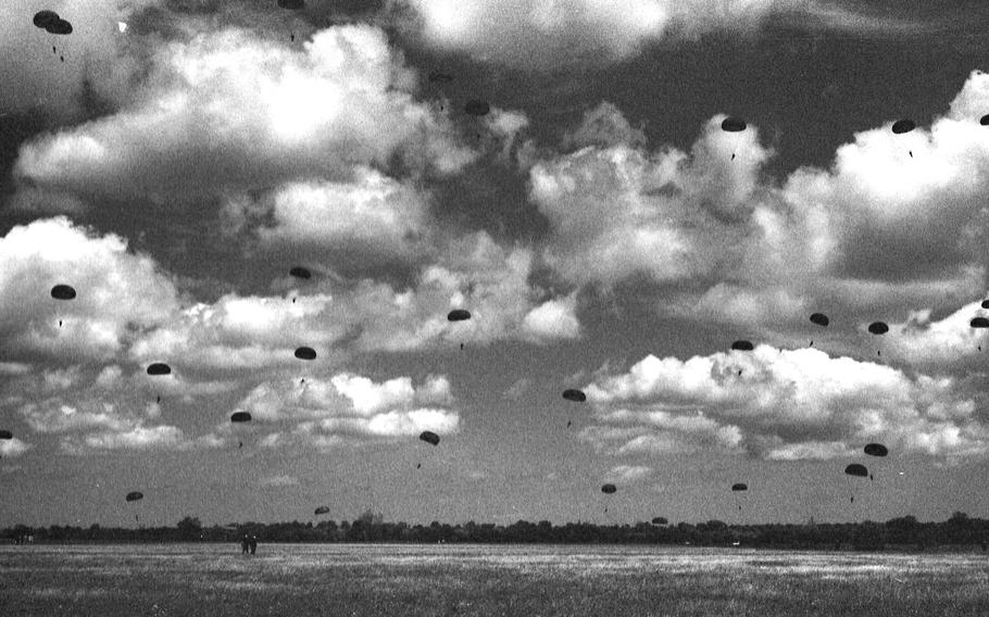 Parachutes glide toward earth as some 550 paratroopers reenacted the 101st Airborne Division D-Day jump, in Normandy, France, June 5, 1994. Nineteen of them were veterans of the actual landing 50 years ago who had fought to liberate the small town of Sainte-Mère-Église. They were the first to jump, together with 22 other World War II combat paratrooper veterans. 