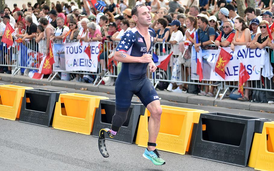 Marine veteran Eric McElvenny pushes through the run portion of the men's PTS4 triathlon on Monday, Sept. 2, 2024, at the 2024 Paralympic Games in Paris. McElvenny finished ninth in the race.