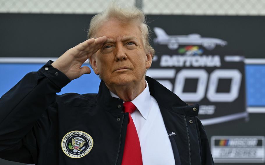 Trump salutes during a flyover.