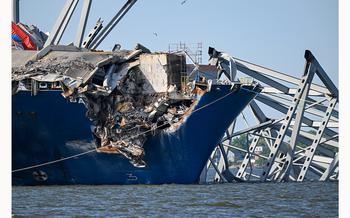 A section of I-695 is still draped across the bow of the container ship Dali that cut apart a section of steel truss from the Francis Scott Key bridge.