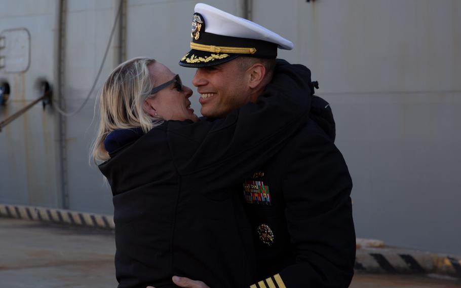 A sailor prepare to kiss his wife.