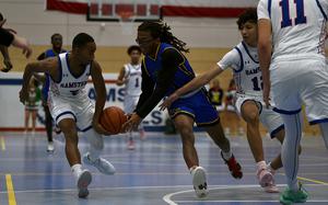 Ramstein's Ky'Ron Hall, left, knocks the ball away from Wiesbaden point guard Jordan Thibodeaux during a Dec. 17, 2024, game at Ramstein High School on Ramstein Air Base, Germany.