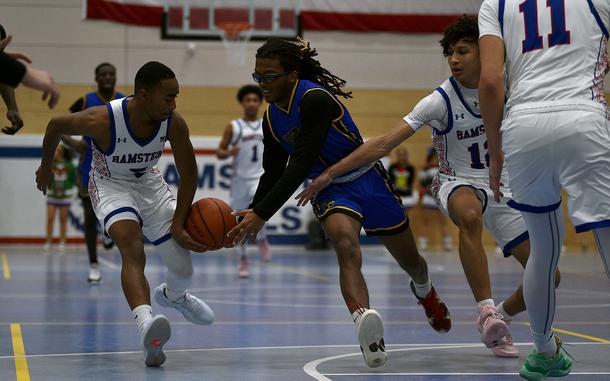 Ramstein's Ky'Ron Hall, left, knocks the ball away from Wiesbaden point guard Jordan Thibodeaux during a Dec. 17, 2024, game at Ramstein High School on Ramstein Air Base, Germany.