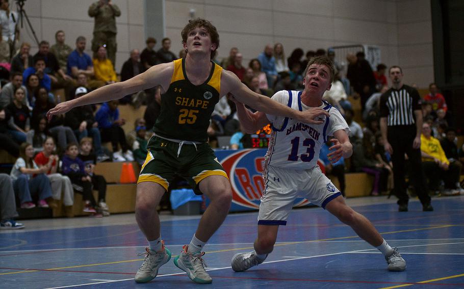 Keller Schutt, Rhett Dalling battle for a rebound.