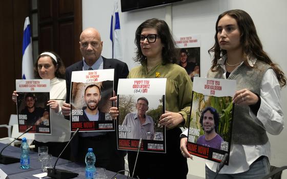 From left, Elena Troufanov, Louis Har, Sharon Lifschitz, and Gaya Kalderon former Israeli hostages and relatives of some still being held by Hamas hold photos at the end of a press conference in Rome, Thursday, Nov. 14, 2024. (AP Photo/Alessandra Tarantino)